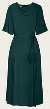 Load image into Gallery viewer, A dark green midi dress with a draped cowl neckline, short flutter sleeves, a matching fabric tie belt at the waist, and tassel details, shown against a plain light background.