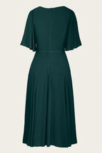 Load image into Gallery viewer, A dark green midi dress with short flutter sleeves, a defined waist, and a pleated skirt, shown from the back against a light cream background.