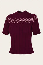 Load image into Gallery viewer, A short-sleeve ribbed knit sweater in deep burgundy with a light pink geometric diamond pattern across the chest and shoulders, shown against a plain off-white background.