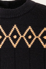 Load image into Gallery viewer, Close-up of a black ribbed knit sweater featuring a tan geometric diamond pattern across the chest.