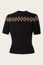 Load image into Gallery viewer, A black short-sleeve ribbed knit sweater featuring a decorative geometric diamond pattern in tan and brown across the chest, displayed on a light cream background.