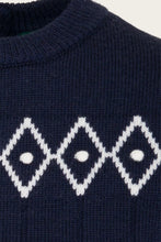 Load image into Gallery viewer, Close-up of a navy blue knit sweater with a white argyle diamond pattern across the chest.