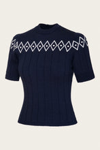 Load image into Gallery viewer, A navy blue short-sleeve knit sweater with a white geometric diamond pattern across the chest, displayed on a neutral light beige background.