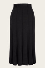 Load image into Gallery viewer, A black high-waisted pleated midi skirt shown on a headless mannequin against a light off-white background.