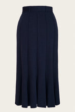 Load image into Gallery viewer, A high-waisted, navy blue pleated midi skirt shown against a plain off-white background.