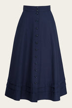 Load image into Gallery viewer, Navy blue skirt with button details on a beige background