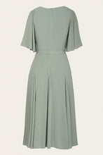 Load image into Gallery viewer, A sage green midi dress with short flutter sleeves, a defined waist, and a pleated skirt, shown from the back against a light cream background.