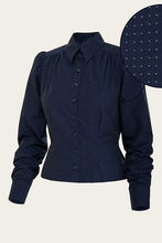 Load image into Gallery viewer, A dark navy blue long-sleeve button-up blouse with a subtle micro-check pattern, featuring a pointed collar and gathered shoulders. A circular inset in the top right highlights the navy fabric with small white polka dots.