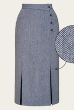 Load image into Gallery viewer, A high-waisted, knee-length gray herringbone skirt with a buttoned waistband and side slits, shown on a light beige background with a circular fabric detail inset.