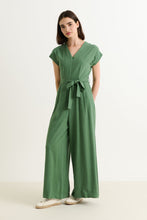 Load image into Gallery viewer, Woman wearing a green jumpsuit on a white background