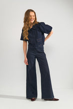 Load image into Gallery viewer, Woman wearing a dark denim jeans on a white background