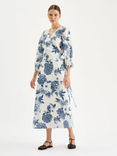 Load image into Gallery viewer, Woman wearing a blue floral dress on a white background