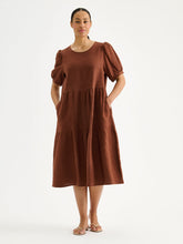 Load image into Gallery viewer, Woman wearing a brown dress with puff sleeves on a white background