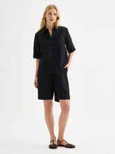Load image into Gallery viewer, Woman wearing a black shirt and shorts on a white background