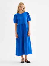 Load image into Gallery viewer, Woman wearing a blue dress on a white background