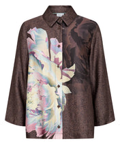 Load image into Gallery viewer, A women's long-sleeve button-up shirt with a split design: one side features a brown leopard print, and the other side features a large pastel floral print with pink, blue, and cream tones. The shirt has a pointed collar and button front.