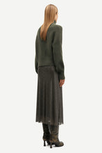 Load image into Gallery viewer, A woman shown from the back wearing a dark olive green knit sweater, a dark gray pleated midi skirt, and dark brown boots against a plain light gray studio background.