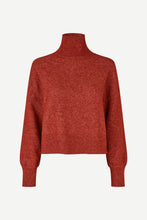 Load image into Gallery viewer, A cropped, long-sleeve turtleneck sweater in a heathered red knit, shown against a plain light gray background.