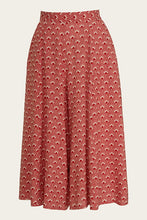Load image into Gallery viewer, Red patterned skirt on a beige background