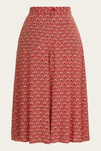 Load image into Gallery viewer, Red patterned skirt on a beige background
