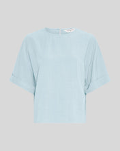 Load image into Gallery viewer, Light blue t-shirt on a gray background