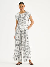 Load image into Gallery viewer, Woman wearing a black and white patterned dress on a white background