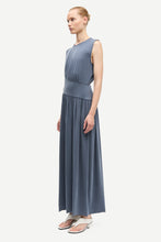 Load image into Gallery viewer, Woman wearing a long blue dress on a white background