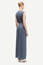 Load image into Gallery viewer, Woman wearing a long blue dress on a white background