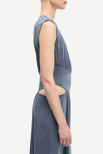 Load image into Gallery viewer, Woman wearing a sleeveless blue dress on a white background
